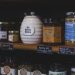 Explore artisanal honey jars and local products neatly displayed on wooden shelves in a charming Dutch shop.